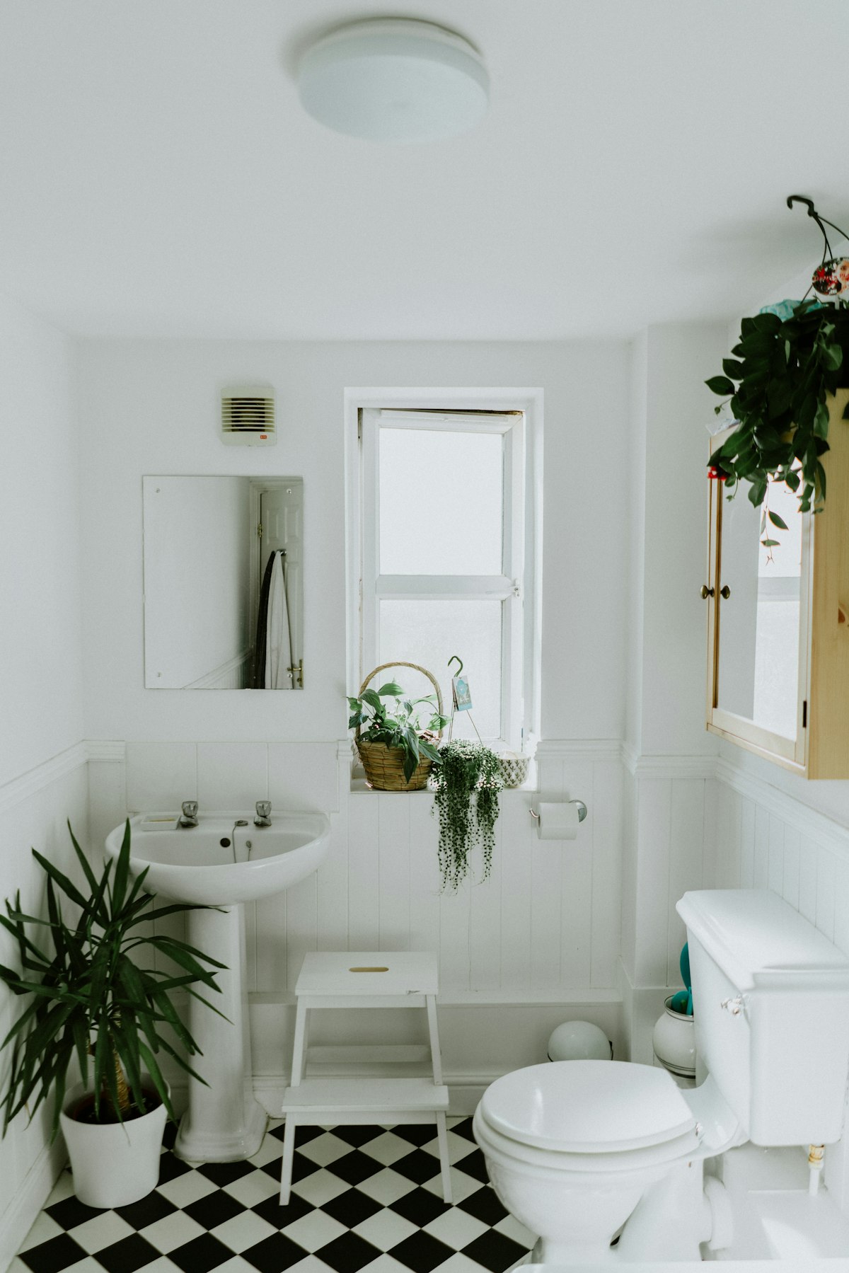 A level-access wet room with a fold-down shower seat, two grab rails and a glazed screen.