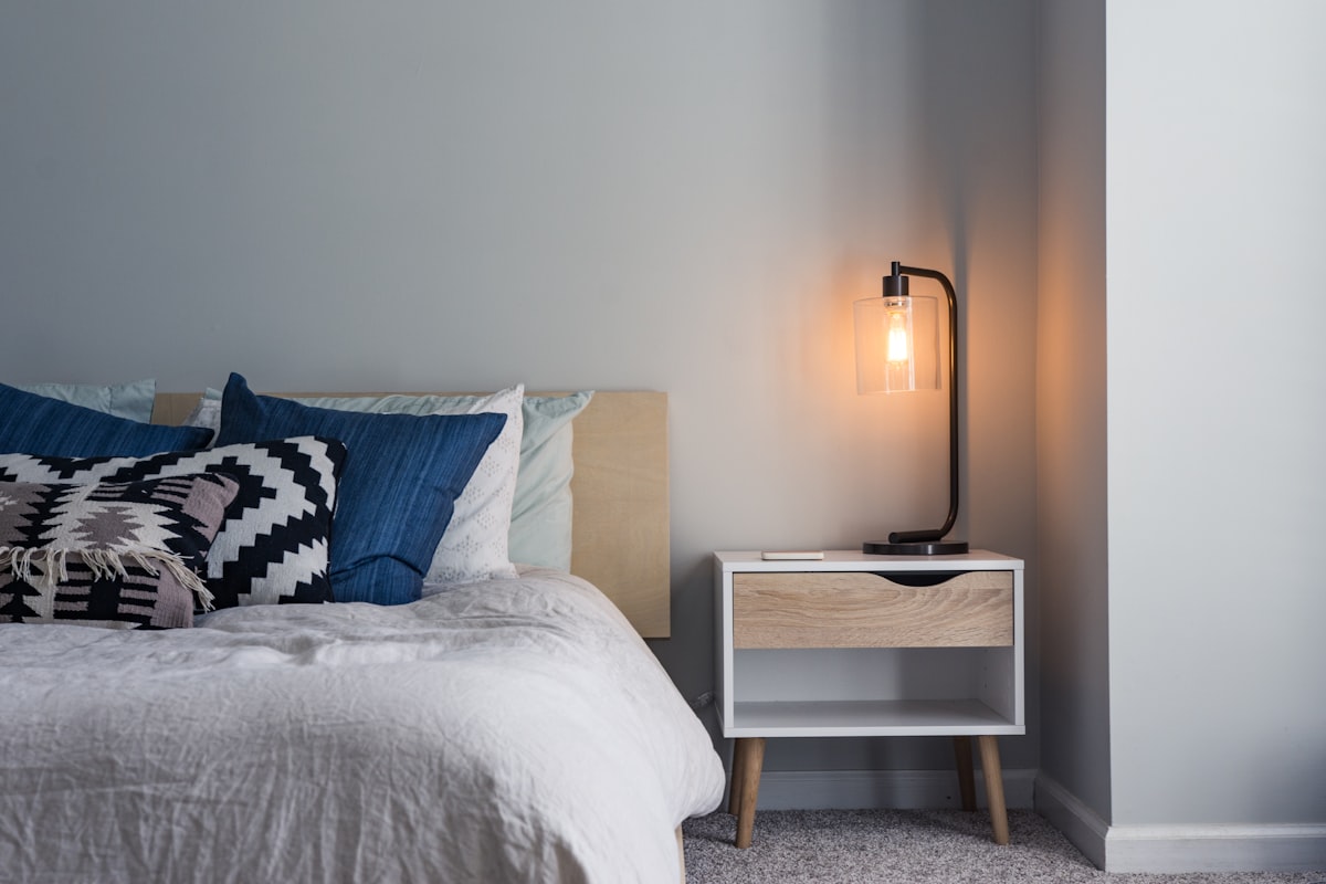 A bedroom with a profiling bed and a ceiling track.